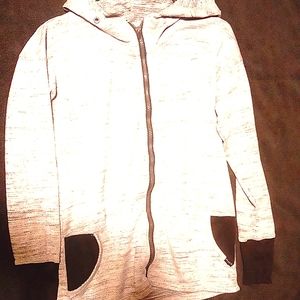 A gray jacket with thumb wholes with hood